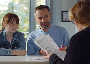 Parent and child meeting with a professional, discussing parenting facilitator services.